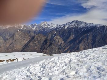 Scenic view of snow covered mountains against sky