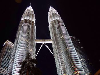 Low angle view of illuminated tower at night