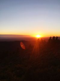 Silhouette landscape against sky during sunset