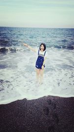 Woman standing on beach