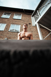 Low angle view of shirtless man