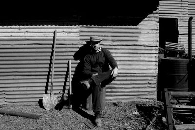 Full length of man sitting on floor