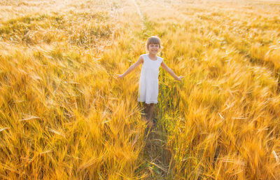 Full length of girl standing on grassy field