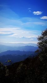 Scenic view of mountains against blue sky
