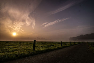 Scenic view of field against sky during sunset