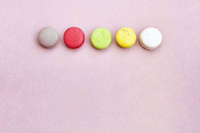 High angle view of multi colored candies against white background