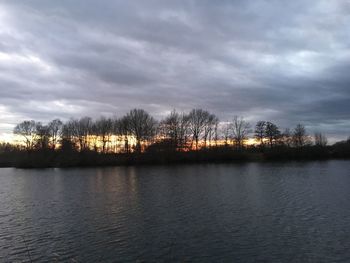 Scenic view of lake against cloudy sky