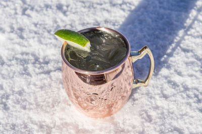 Close-up of drink on snow covered field