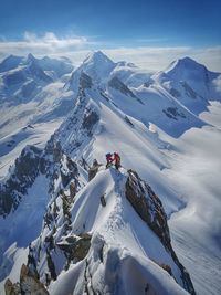 High angle view of hikers standing on snowcapped mountain at zermatt