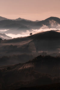 Scenic view of silhouette mountains against sky during sunset