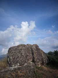 Low angle view of rock formations against sky