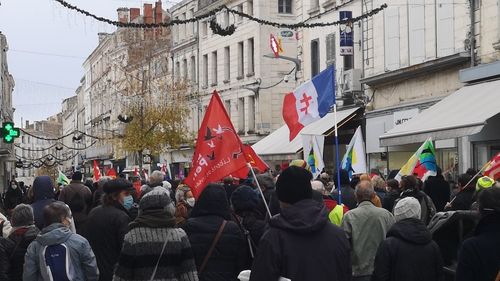 Group of people on street against buildings in city