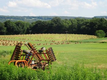 Farm implement on field against sky