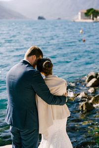 Rear view of man standing at sea shore