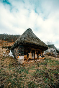 Hut on land against sky