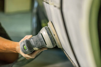 Bulgarian mechanic working in auto shop.