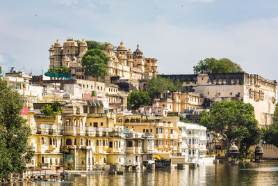 Buildings by lake in city