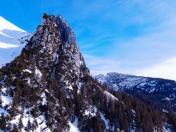 Low angle view of snowcapped mountain against sky