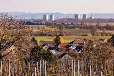 View of a nuclear power plant with houses and vineyards in the foreground