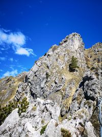 Low angle view of rock formation against sky