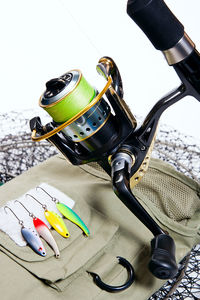 Close-up of fishing equipment over white background