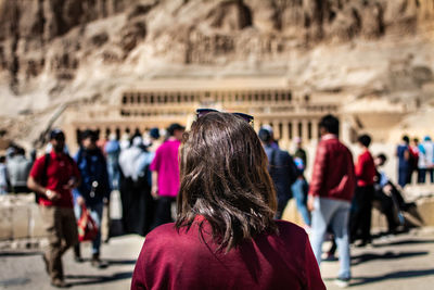 Rear view of people walking in city