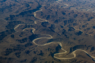 Oman, dhofar governorate, aerial view of dry riverbed in winding canyon