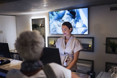 Receptionist assisting customer at health spa