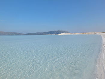 Scenic view of sea against clear blue sky