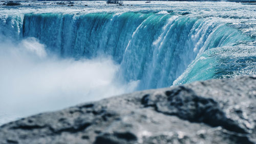 Scenic view of waterfall in sea