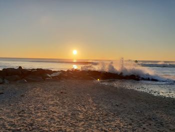 Scenic view of sea against clear sky during sunset