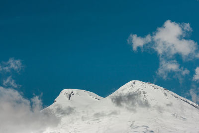 Low angle view of snowcapped mountain against sky