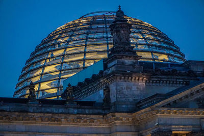 Low angle view of illuminated building against sky