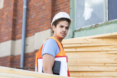Young construction engineer with helmet working outside