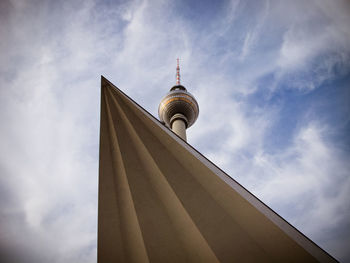 Low angle view of communications tower against sky