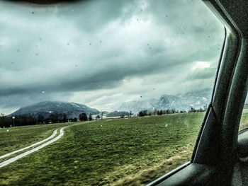Scenic view of landscape seen through car window