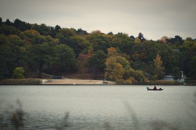 Scenic view of calm lake against trees