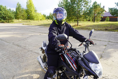 Man riding motorcycle on road