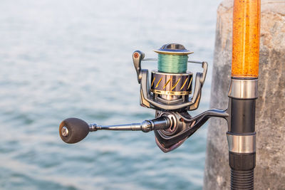 The crank of a fishing rod with reel foot, reel seat, spool, coiled line and spool brake