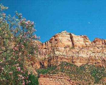 Scenic view of rocky mountains against clear blue sky