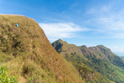 Scenic view of mountain against cloudy sky