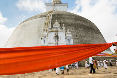 People at temple against building