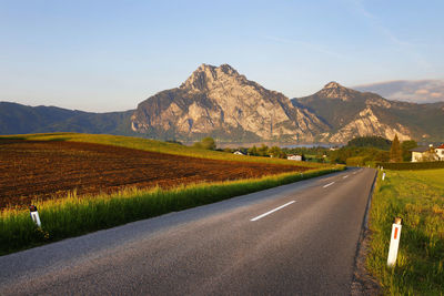 Road amidst mountains against sky