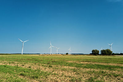 Windmill turbine in the field at summer day. rotating wind generator