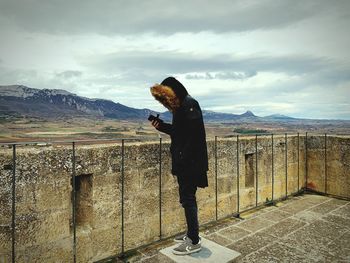 Full length of man standing by landscape