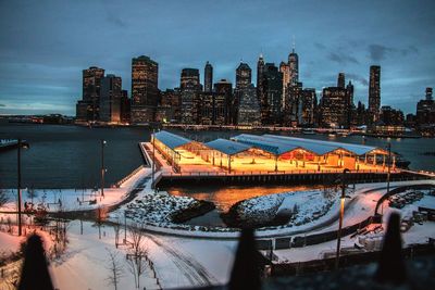 Illuminated city at waterfront