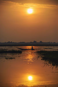 Scenic view of lake against sky during sunset