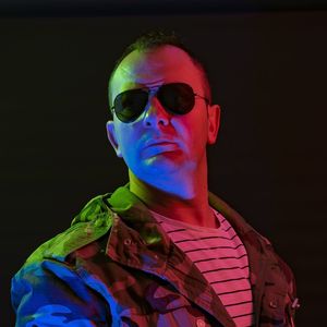 Portrait of young man wearing sunglasses against black background
