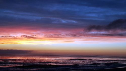 Scenic view of sea against sky at sunset