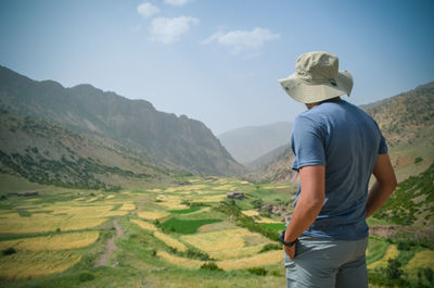 Rear view of man looking at mountains